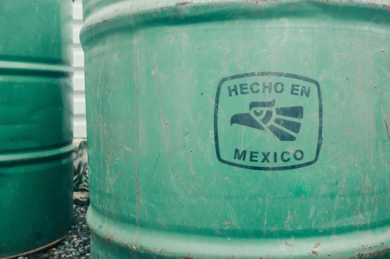 Close-up of a green industrial barrel with 'Hecho en Mexico' text. Ideal for manufacturing themes.