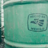Close-up of a green industrial barrel with 'Hecho en Mexico' text. Ideal for manufacturing themes.