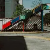 A vibrant pedestrian bridge over quiet urban streets in Mérida, Venezuela.