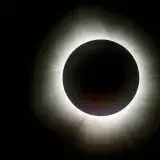 a solar eclipse is seen in the dark sky