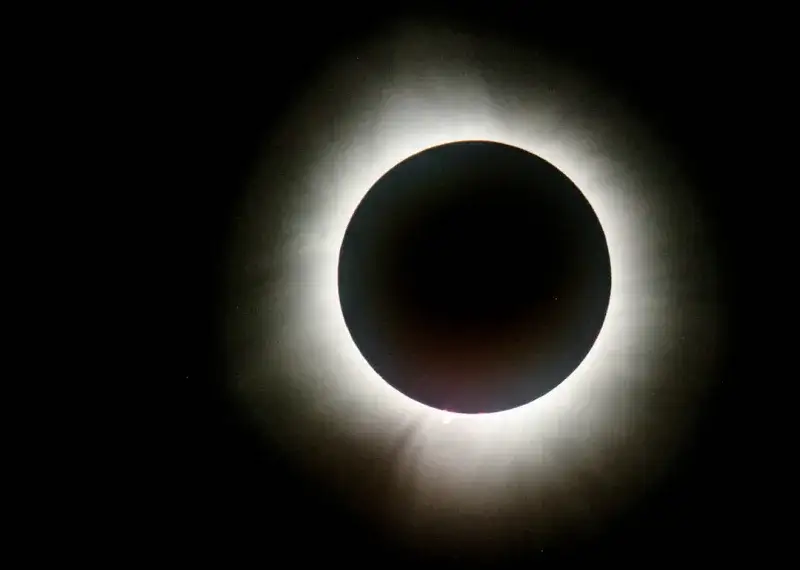 a solar eclipse is seen in the dark sky