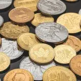 A detailed view of various gold and silver coins, ideal for financial themes.