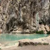 Beautiful natural rock formation surrounding a tranquil lagoon in Huancaraylla, Ayacucho, Peru.