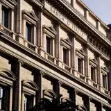 Sunlit facade of the iconic Banca d'Italia in Rome, showcasing classic architecture.
