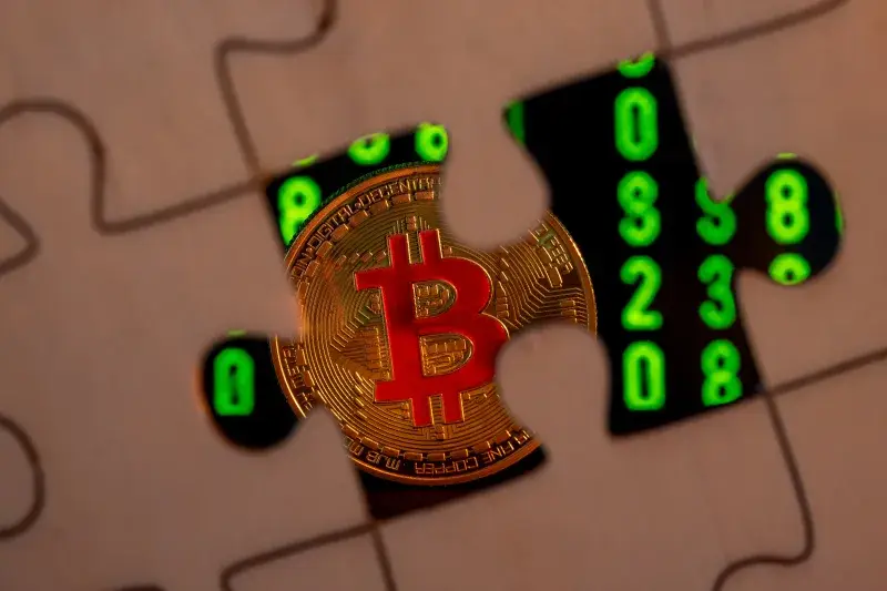 Gold Bitcoin emerging from a jigsaw puzzle piece, symbolizing digital currency and enigmatic cryptocurrency market.