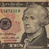 Detailed close-up image of a US ten dollar bill with Alexander Hamilton's portrait.